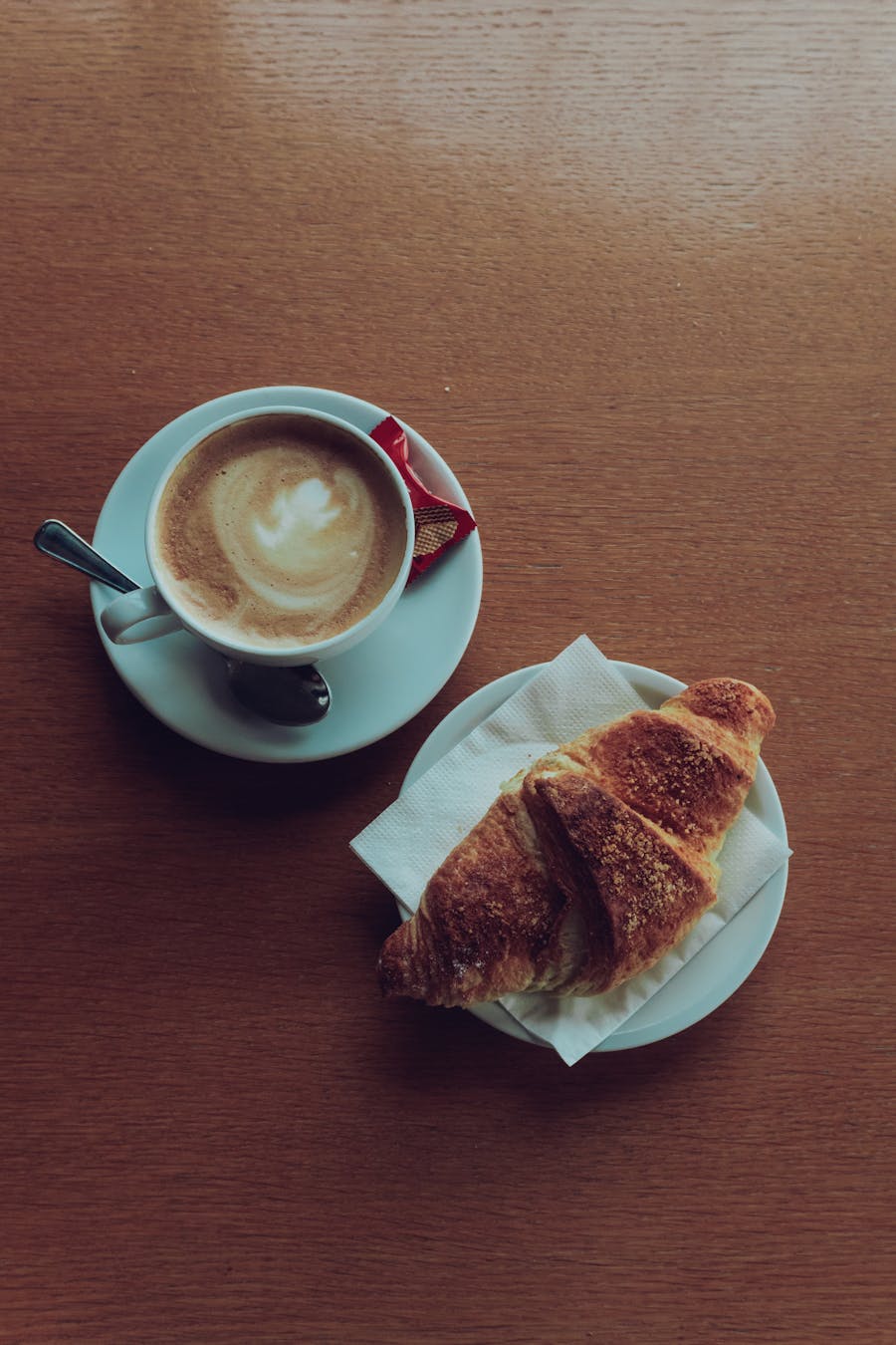 Morning coffee and croissant on a café table